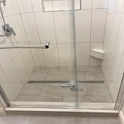 Linear shower drain and foot prop